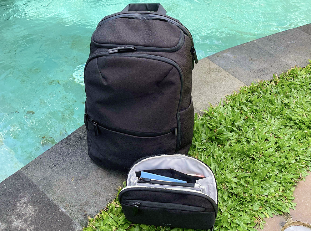 The Kuro Switchpack and detached essentials sling by a pool
